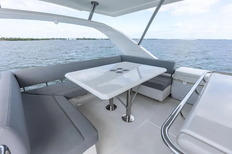 Slide: The Image of Aquila 44 Yacht 2021 interior with sleek seating and table on open water. - 42