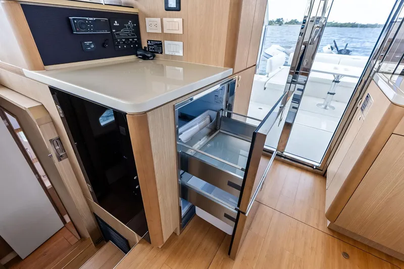 Slide: The Image of Interior of 2021 Aquila 44 Yacht with open drawer fridge and control panel. - 45