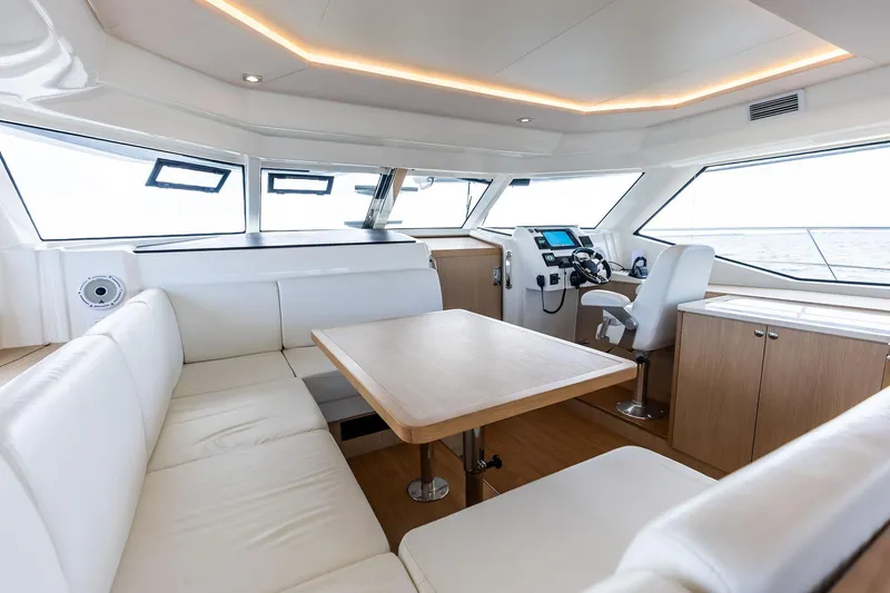 Slide: The Image of Luxurious interior of 2021 Aquila 44 Yacht with modern seating and navigation area. - 49