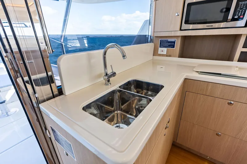 Slide: The Image of Modern kitchen area on 2021 Aquila 44 Yacht with sink and microwave. - 53