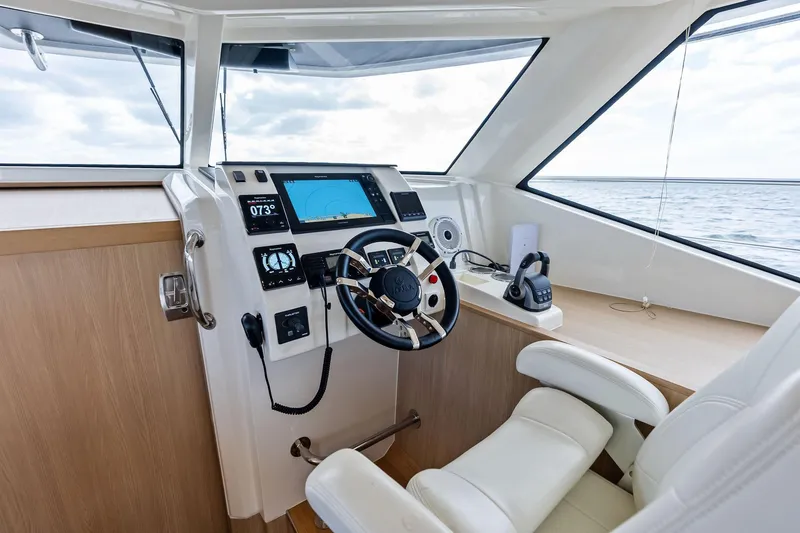 Slide: The Image of Helm station of 2021 Aquila 44 Yacht with modern navigation equipment and luxurious seating. - 54