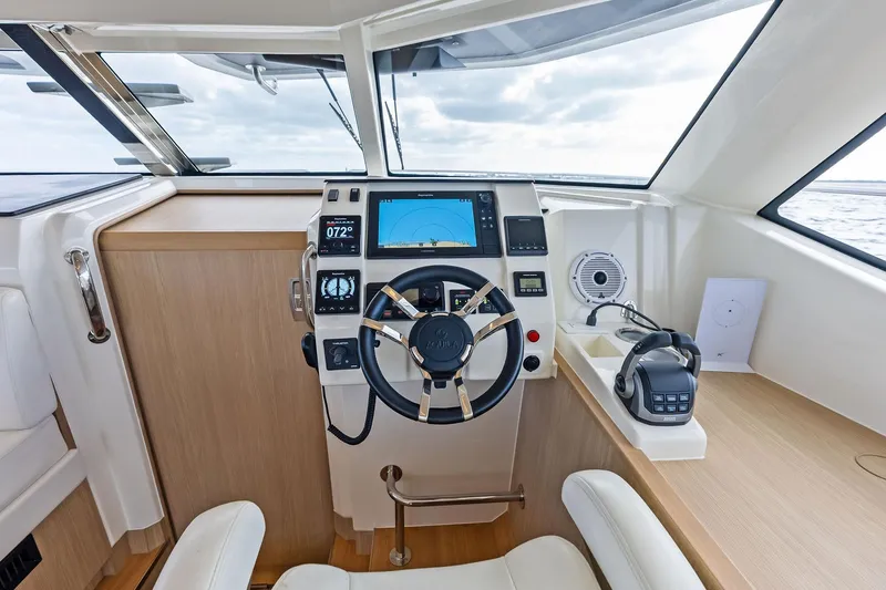 Slide: The Image of Cockpit of 2021 Aquila 44 Yacht with modern navigation controls and steering wheel. - 55