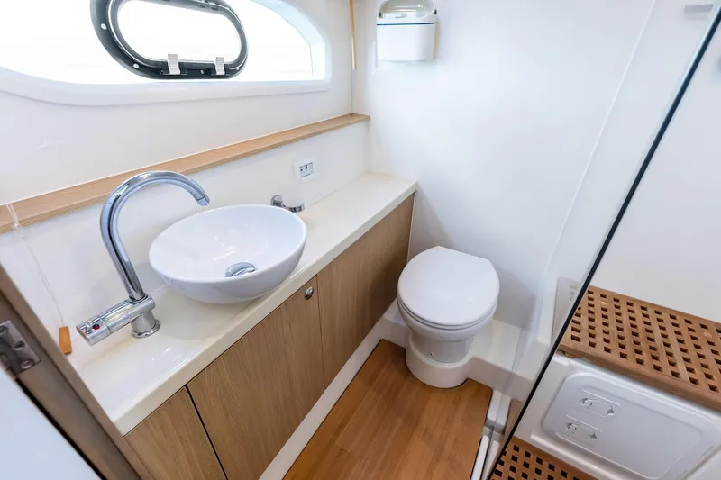 Slide: The Image of Modern bathroom in 2021 Aquila 44 Yacht with sink, toilet, and wooden accents. - 59