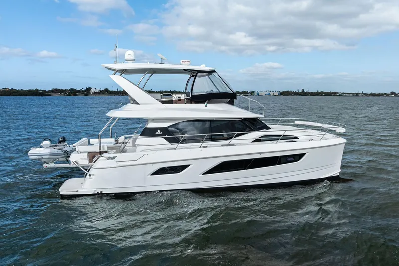 Slide: The Image of 2021 Aquila 44 Yacht cruising on open water under a partly cloudy sky. - 6