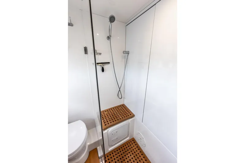 Slide: The Image of Shower area in 2021 Aquila 44 Yacht with wooden flooring and modern fixtures. - 60