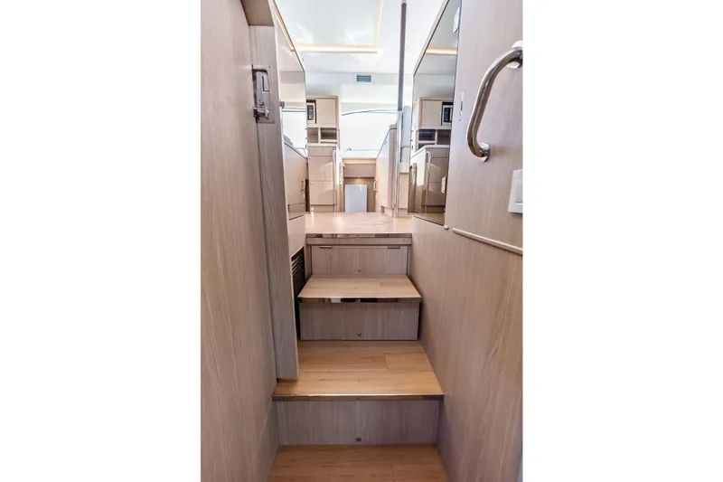 Slide: The Image of Interior stairs of 2021 Aquila 44 Yacht, featuring modern wood finish and sleek design. - 61