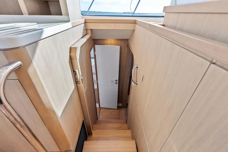 Slide: The Image of Interior staircase of 2021 Aquila 44 Yacht, featuring sleek wooden design and modern finishes. - 62