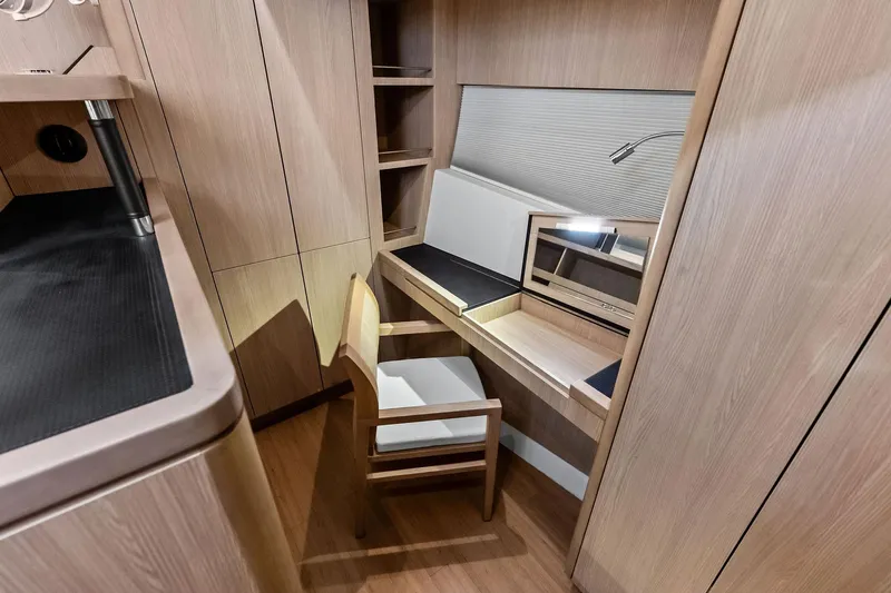 Slide: The Image of Interior of 2021 Aquila 44 Yacht featuring a modern wooden desk and chair setup. - 67