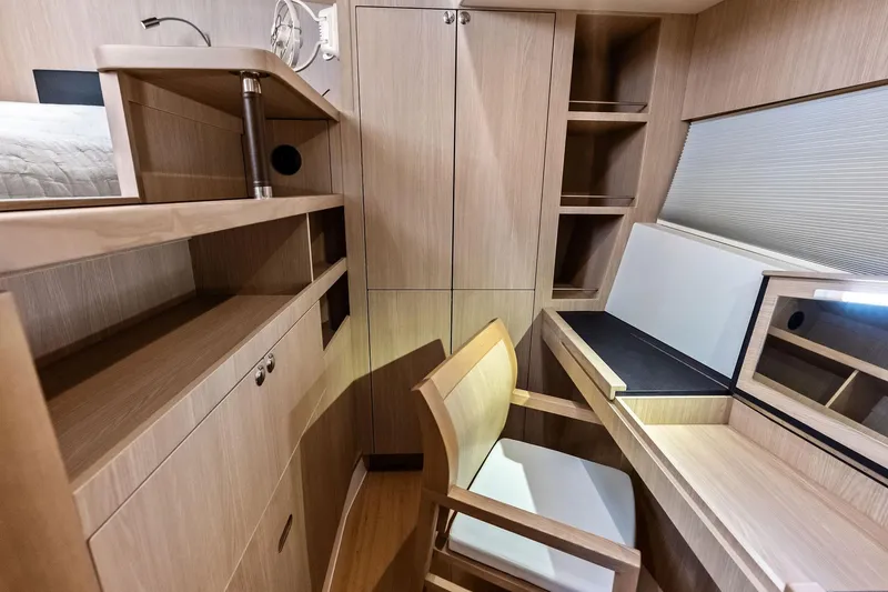 Slide: The Image of Interior of 2021 Aquila 44 Yacht featuring a modern wooden desk and chair setup. - 68
