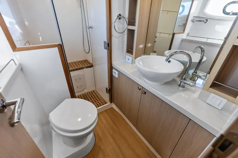 Slide: The Image of Modern bathroom interior on 2021 Aquila 44 Yacht, featuring sink, toilet, and shower. - 69