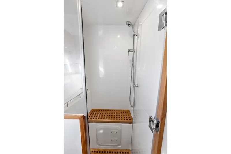Slide: The Image of Shower area in 2021 Aquila 44 Yacht with wooden flooring and modern fixtures. - 70