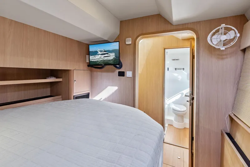 Slide: The Image of Interior cabin of 2021 Aquila 44 Yacht with bed, TV, and bathroom. - 73