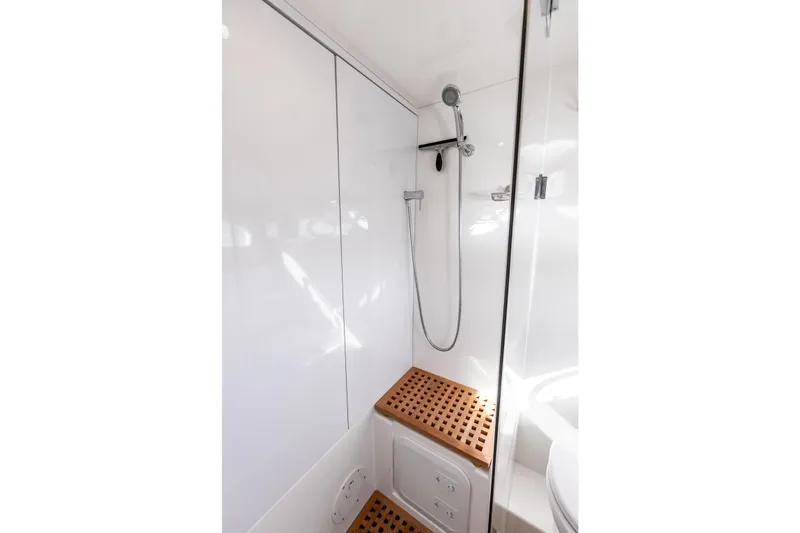 Slide: The Image of Modern shower area in 2021 Aquila 44 Yacht with sleek design and wooden accents. - 75