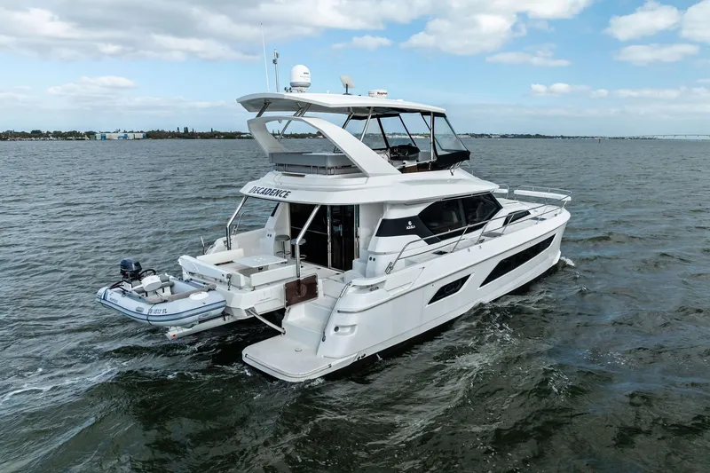 Slide: The Image of 2021 Aquila 44 Yacht cruising on open water under a partly cloudy sky. - 8