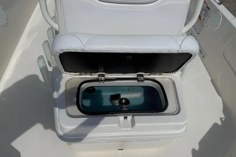 Slide: The Image of 2024 Skeeter SX210 boat livewell with open lid, showcasing interior features. - 10
