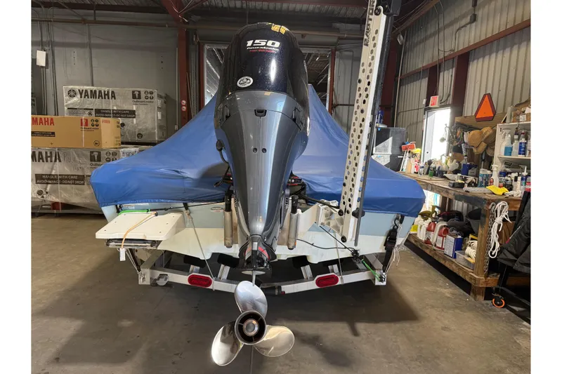 Slide: The Image of 2024 Skeeter SX210 boat with Yamaha engine in a garage setting. - 16