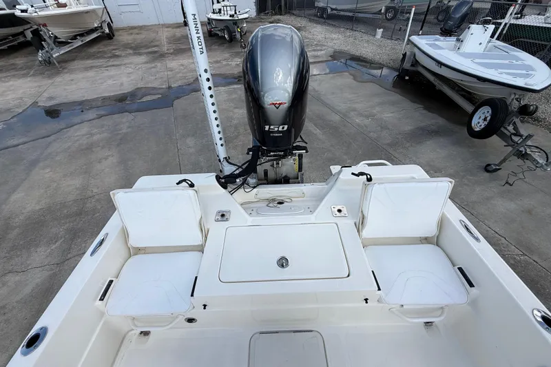 Slide: The Image of 2024 Skeeter SX210 boat with Yamaha 150 engine, docked on concrete surface. - 8