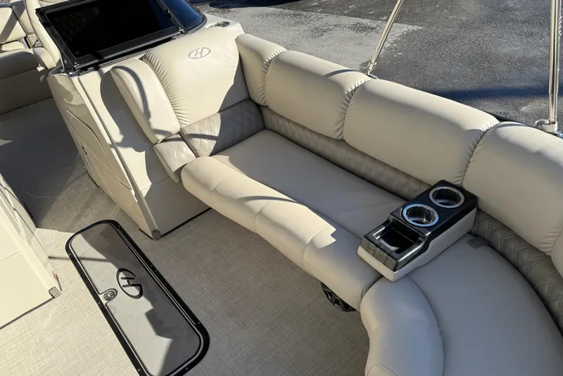Slide: The Image of 2019 Harris Solstice DC 230 boat interior with beige seating and cup holders. - 11