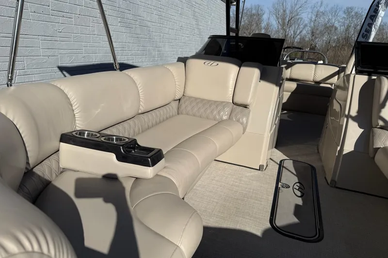 Slide: The Image of 2019 Harris Solstice DC 230 boat interior with beige leather seating and cup holders. - 12