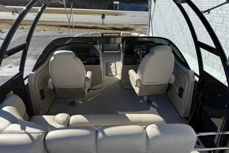 Slide: The Image of Interior of a 2019 Harris Solstice DC 230 boat with beige seating and steering console. - 6