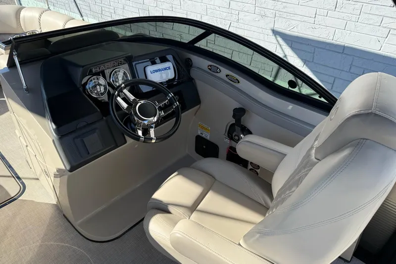 Slide: The Image of 2019 Harris Solstice DC 230 boat cockpit with steering wheel and navigation display. - 8