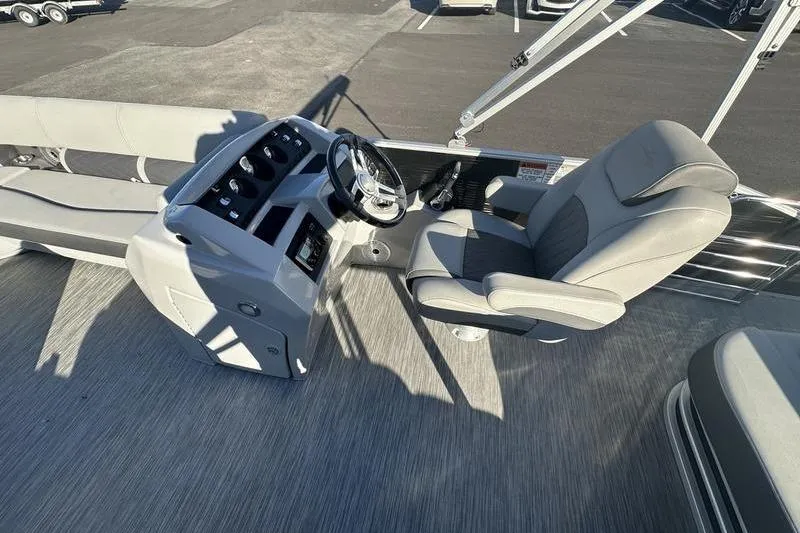 Slide: The Image of 2021 Bennington 23 LSB boat interior with steering console and captain's chair. - 12