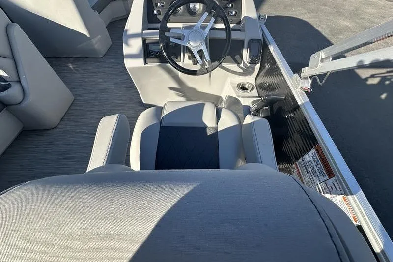 Slide: The Image of 2021 Bennington 23 LSB boat interior with steering wheel and seating. - 14