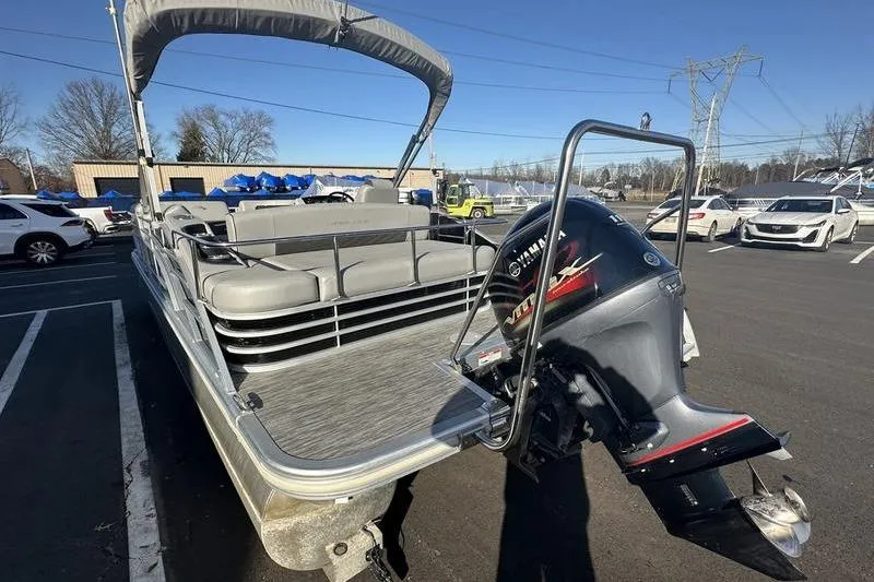 Slide: The Image of 2021 Bennington 23 LSB pontoon boat with Yamaha outboard motor in parking lot. - 8