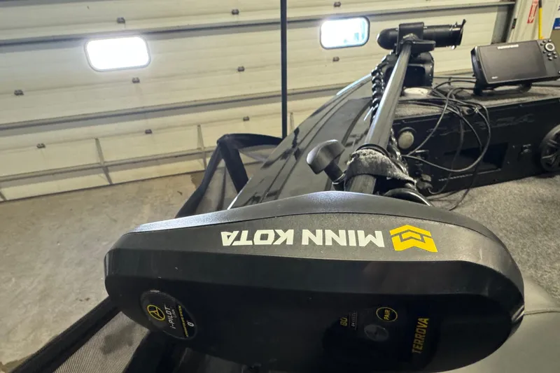 Slide: The Image of 2020 Tracker Targa V-19 Combo with Minn Kota trolling motor in garage. - 20
