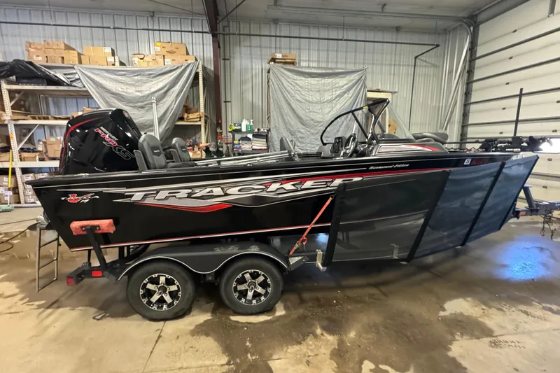 Slide: The Image of 2020 Tracker Targa V-19 Combo Tournament Edition boat in a garage setting. - 3
