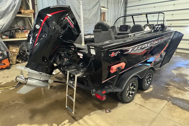 Slide: The Image of 2020 Tracker Targa V-19 Combo Tournament Edition boat in garage, rear view. - 4