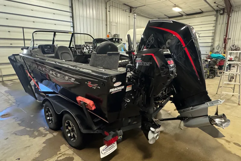 Slide: The Image of 2020 Tracker Targa V-19 Combo Tournament Edition boat in a garage setting. - 5