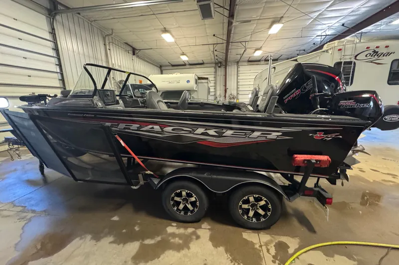 Slide: The Image of 2020 Tracker Targa V-19 Combo Tournament Edition boat in indoor storage. - 6