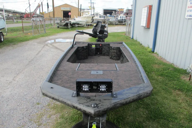 Slide: The Image of 2026 Gator Tail 1754 Extreme boat parked outdoors near industrial area. - 2