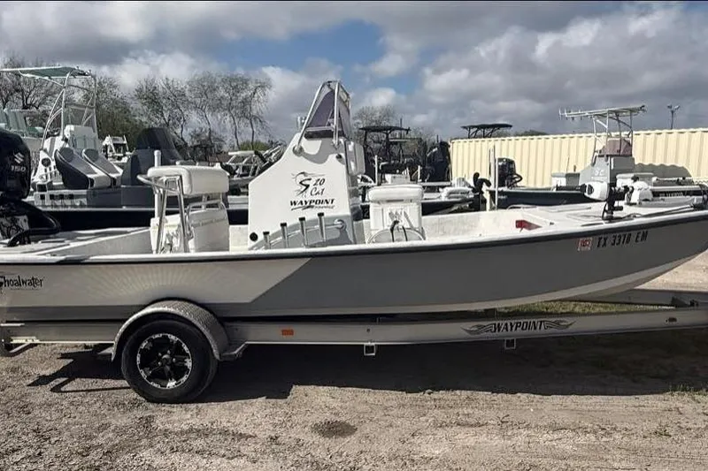 The Image of 2019 Shoalwater 20 Catamaran on trailer, parked outdoors under cloudy sky. - 1