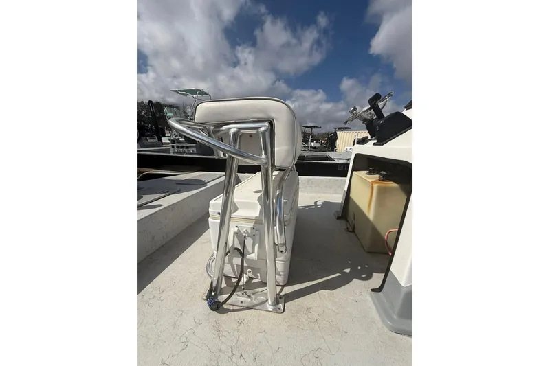 Slide: The Image of 2019 Shoalwater 20 Catamaran interior with seating and steering console under a cloudy sky. - 11