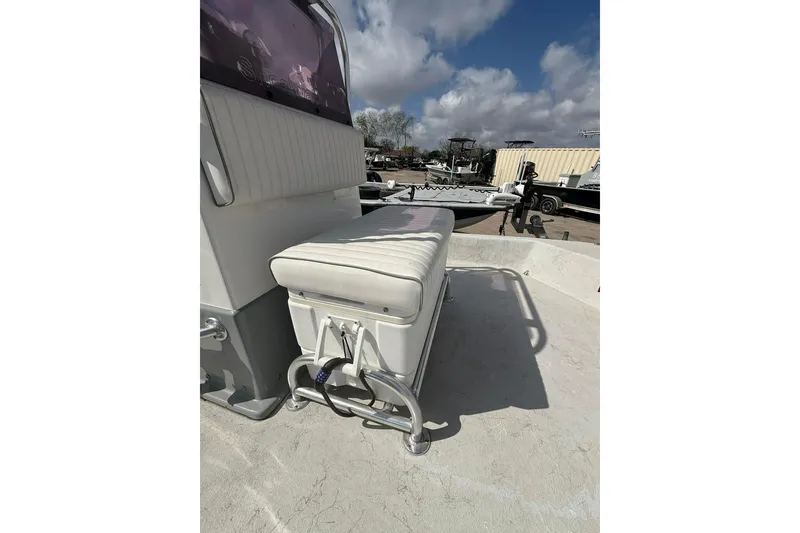 Slide: The Image of 2019 Shoalwater 20 Catamaran boat interior with cushioned seating under a cloudy sky. - 12