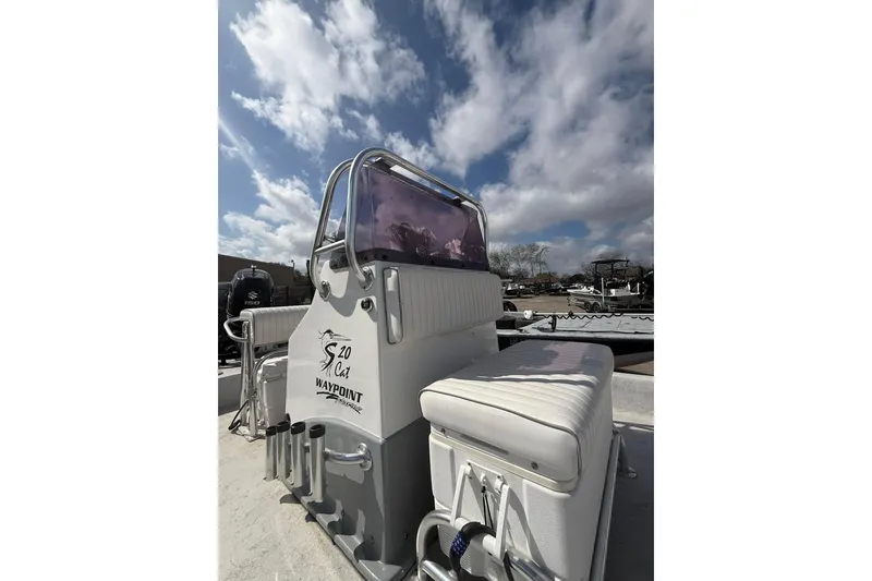 Slide: The Image of 2019 Shoalwater 20 Catamaran boat with white seating under a cloudy sky. - 4