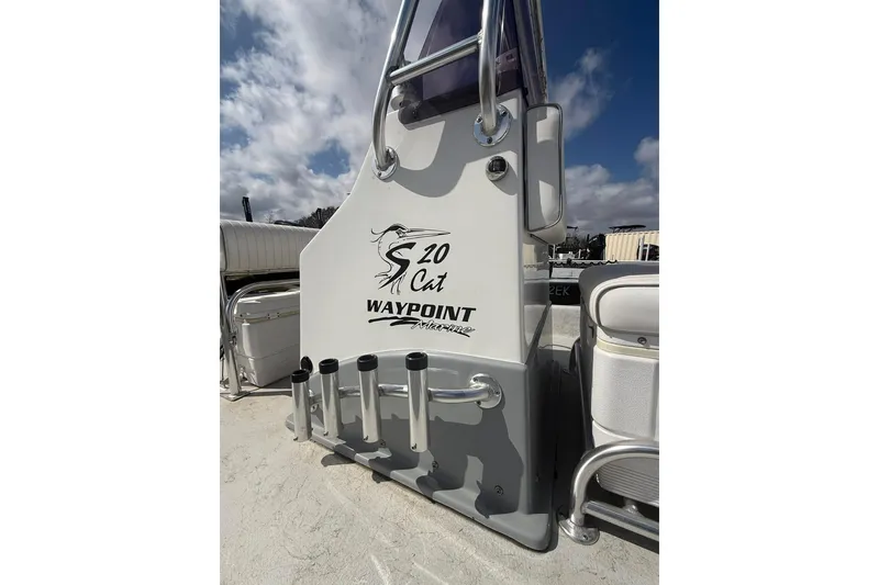 Slide: The Image of 2019 Shoalwater 20 Catamaran boat console with rod holders under a blue sky. - 5