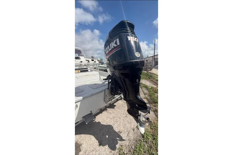 Slide: The Image of 2019 Shoalwater 20 Catamaran with Suzuki 150 outboard motor, parked outdoors. - 7
