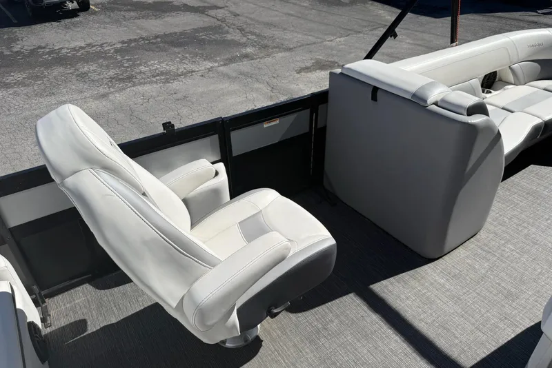 Slide: The Image of 2022 Viaggio Diamante S 26 boat interior with white seating and gray flooring. - 12