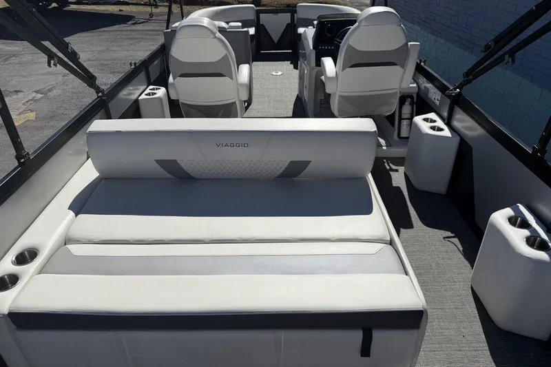 Slide: The Image of 2022 Viaggio Diamante S 26 boat interior with white seating and cup holders. - 14