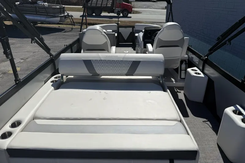 Slide: The Image of 2022 Viaggio Diamante S 26 boat interior with white seating and cup holders. - 15