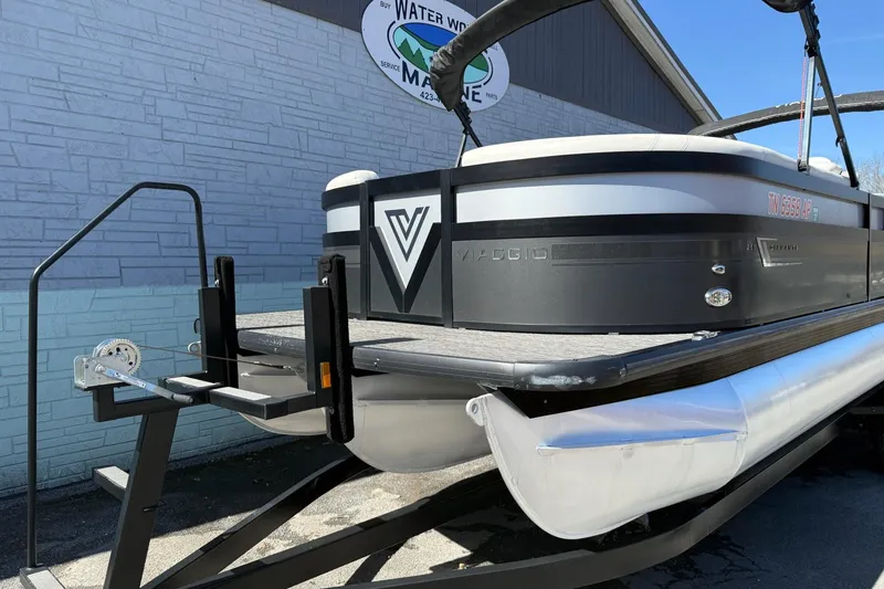 Slide: The Image of 2022 Viaggio Diamante S 26 pontoon boat on trailer outside marine shop. - 3