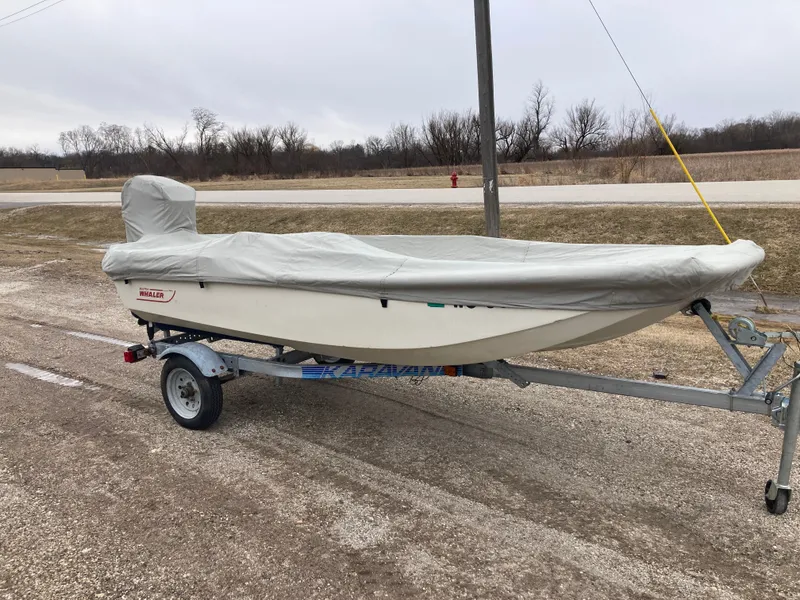 Slide: The Image of 1989 Boston Whaler 13 Sport boat on trailer, covered. - 13