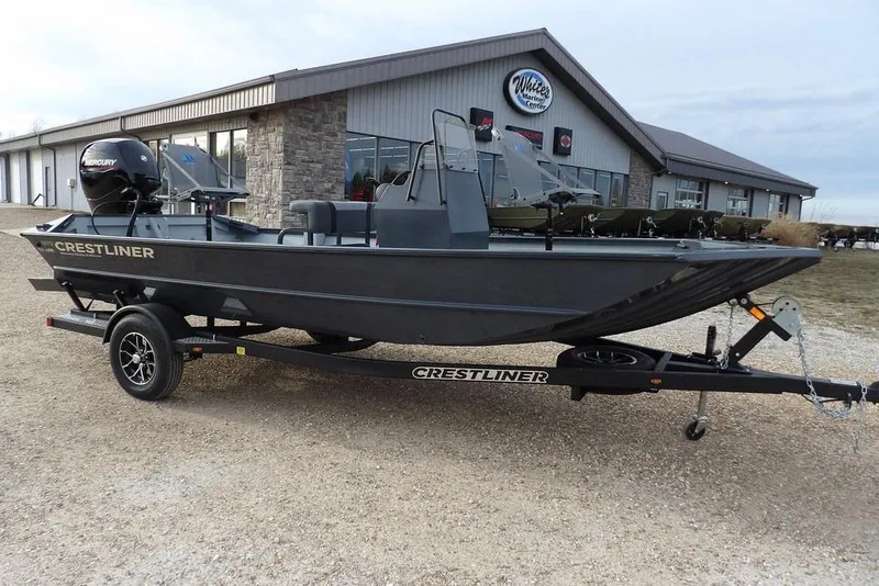 The Image of 2026 Crestliner 1870 Retriever FCC boat on trailer outside marine center. - 1