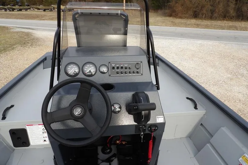 Slide: The Image of 2026 Crestliner 1870 Retriever FCC boat dashboard with steering wheel and control panel. - 17