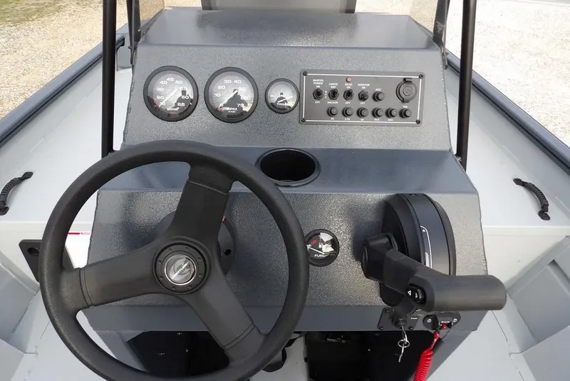 Slide: The Image of 2026 Crestliner 1870 Retriever FCC boat console with steering wheel and control panel. - 20