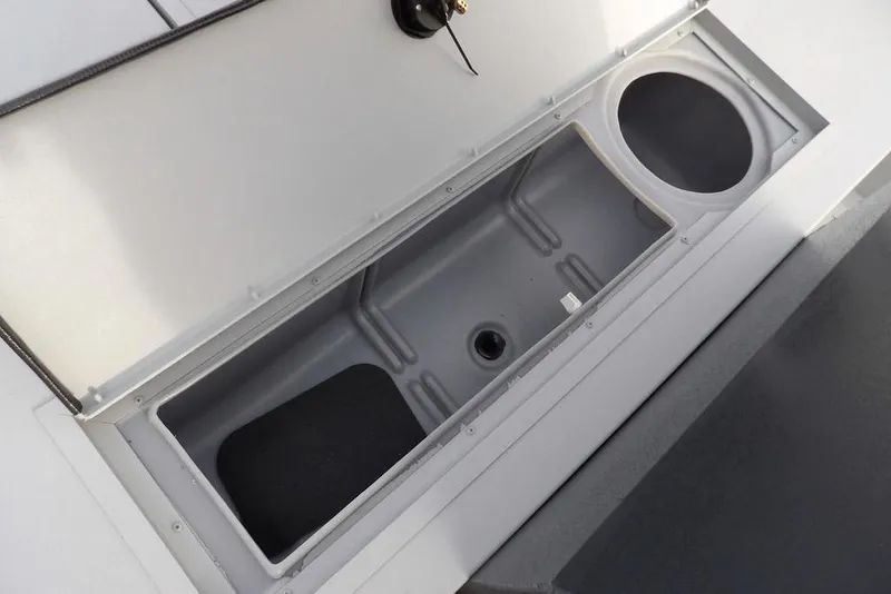 Slide: The Image of 2026 Crestliner 1870 Retriever FCC storage compartment with open lid, showcasing interior space. - 22