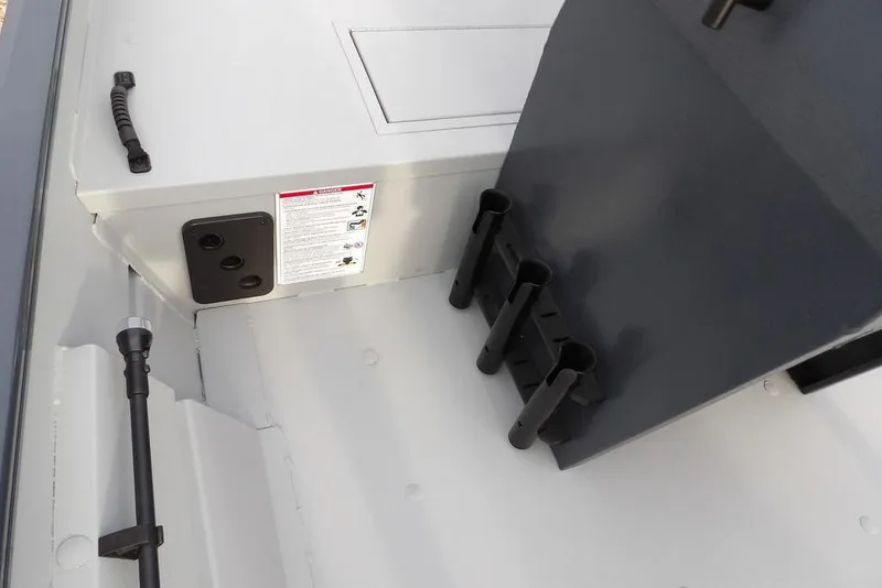 Slide: The Image of 2026 Crestliner 1870 Retriever FCC interior with rod holders and storage compartment. - 24